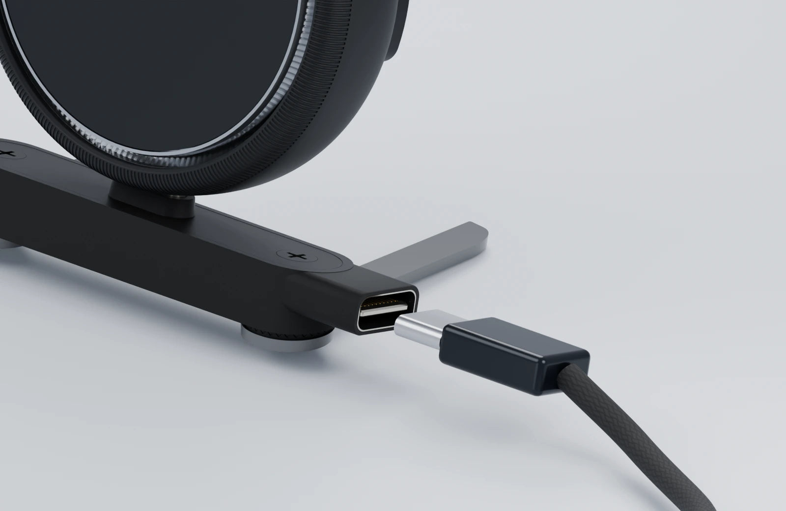 USB-C plug aligned with the charging socket on the side of the mount