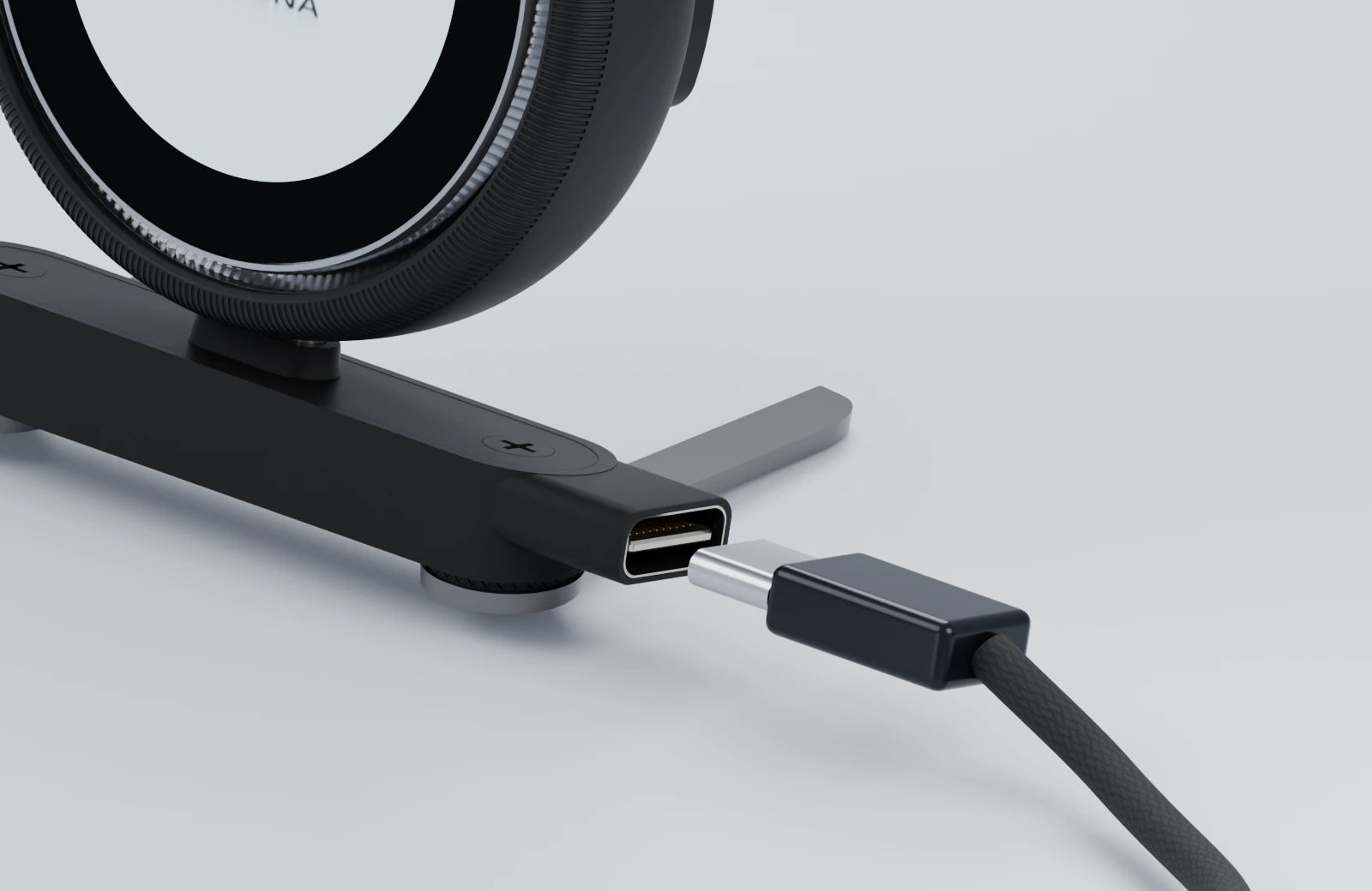 USB-C plug aligned with the charging socket on the side of the mount